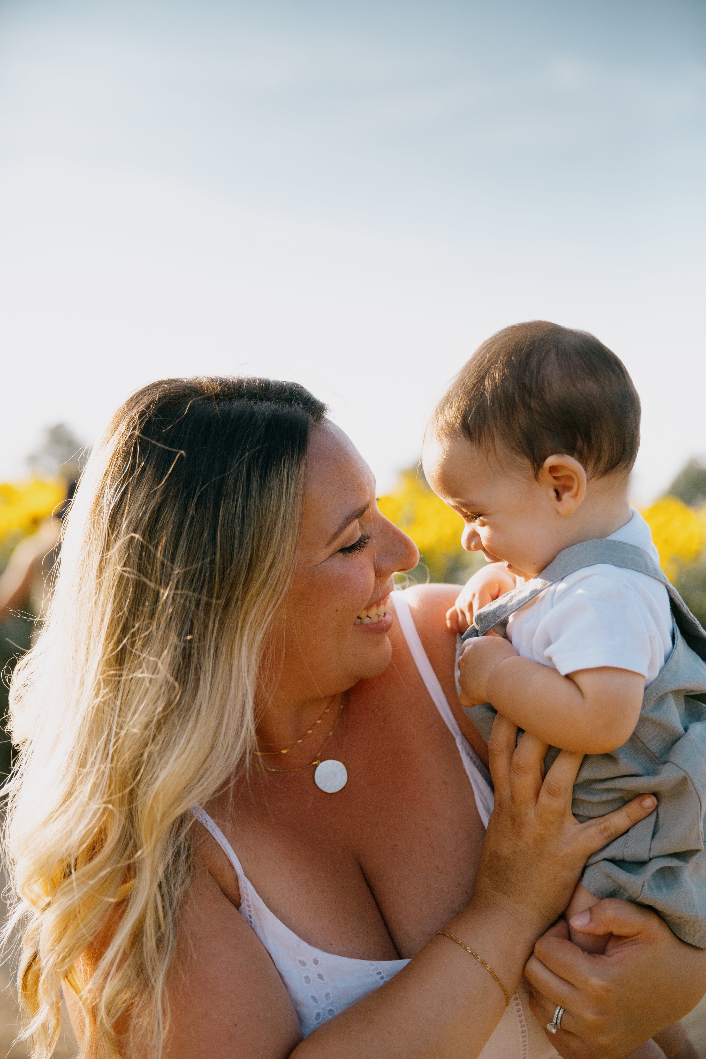 files/person-holds-a-baby-outside-as-they-both-giggle.jpg